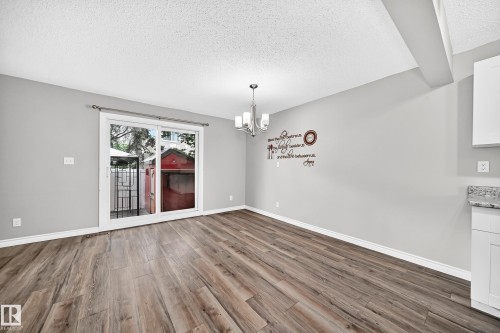 Wood-finish flooring with neutral wall tones and white trim - 18146 81 Avenue Nw, Edmonton, AB 