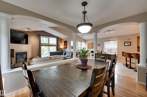 1524 Breckenridge Close Nw, Edmonton, AB - Indoor Photo Showing Dining Room With Fireplace