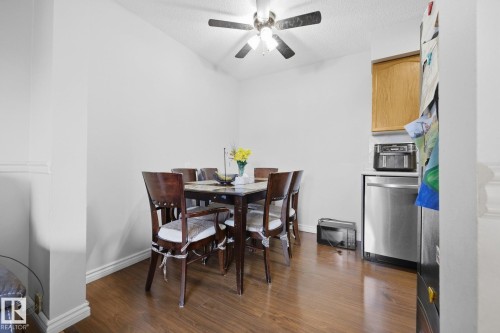 Wood-finish flooring, recessed lighting, and a ceiling fan with integrated lighting - #2 14120 80 St Nw, Edmonton, AB 