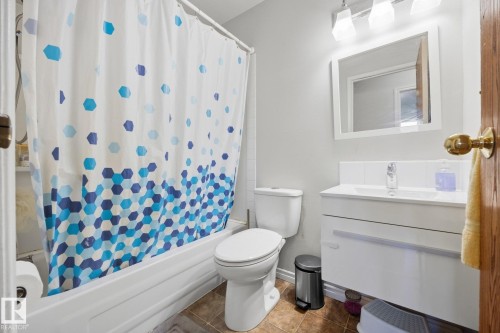 White acrylic bathtub and shower combination with a tiled surround - #2 14120 80 St Nw, Edmonton, AB 