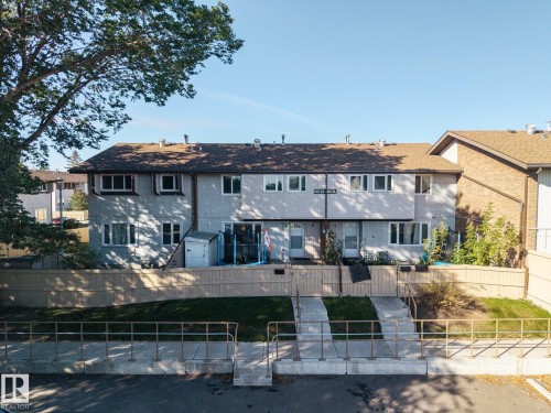 Townhouse complex with a shingled roof and light-colored siding - #2 14120 80 St Nw, Edmonton, AB 