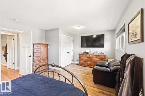 Wood-finish flooring, white trim, recessed lighting, and a window with roller shade - 13427 83 Street Nw, Edmonton, AB 