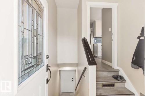 Entry door with decorative glass inserts and dark hardware - 13427 83 Street Nw, Edmonton, AB 