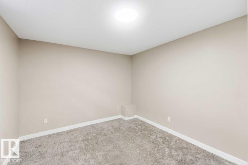 Neutral-toned walls, recessed ceiling light, and gray carpeted flooring - 13427 83 Street Nw, Edmonton, AB 