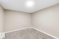 Neutral-toned walls, recessed ceiling light, and gray carpeted flooring - 