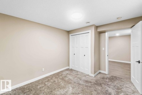 Neutral wall finishes, recessed lighting, white trim, and a built-in closet with bifold doors - 13427 83 Street Nw, Edmonton, AB 