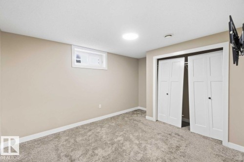 Recessed lighting, light-toned carpeting, neutral wall paint, white trim, and a white window frame - 13427 83 Street Nw, Edmonton, AB 