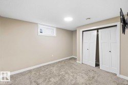 Recessed lighting, light-toned carpeting, neutral wall paint, white trim, and a white window frame - 