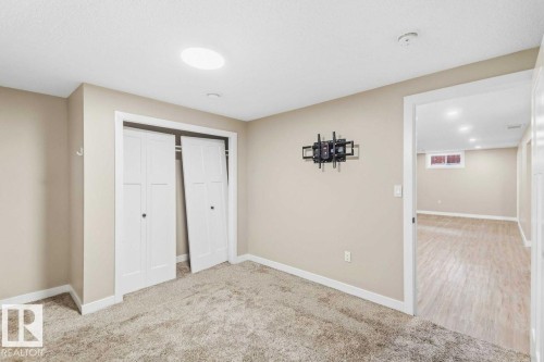 Neutral-toned walls complement plush carpeting - 13427 83 Street Nw, Edmonton, AB 