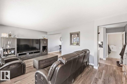 Wood-finish flooring, light gray wall paint, and white trim throughout the space - 13427 83 Street Nw, Edmonton, AB 