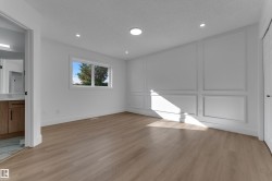 Wood-finish flooring, recessed lighting, and a window with exterior views - 