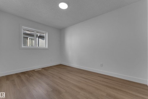 Recessed ceiling lighting, wood-finish flooring, white wall paint, and white trim - 3320 43 Street Nw, Edmonton, AB 