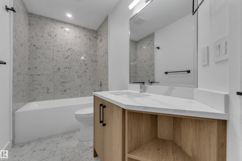 Integrated bathtub with speckled wall tile surround - 3320 43 Street Nw, Edmonton, AB 