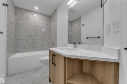 Integrated bathtub with speckled wall tile surround - 
