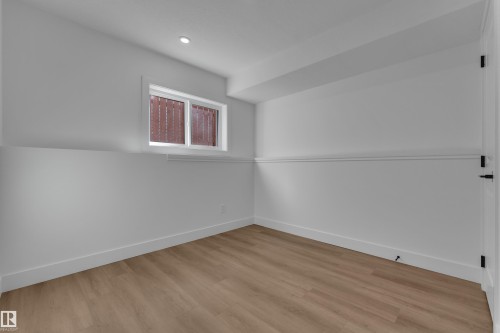 Recessed ceiling lighting, wood-finish flooring, crisp white walls, white trim, and a window for natural illumination - 3320 43 Street Nw, Edmonton, AB 