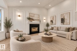 Vaulted ceiling with recessed lighting, wood-finish flooring, fireplace with black tile surround, decorative wall molding, and wall sconces - 