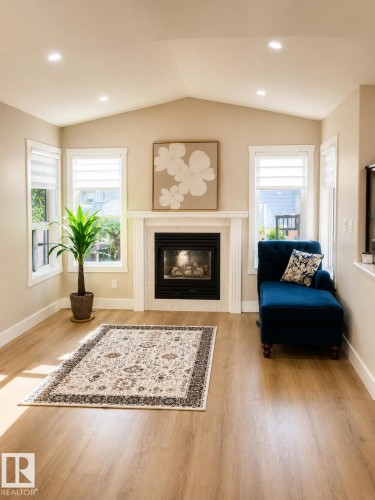 Vaulted ceiling, recessed lighting, wood-finish flooring, fireplace with white mantel, and multiple windows - 3830 22 Street Nw, Edmonton, AB 