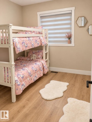 Wood-finish flooring, white trim, and a window with a roller shade - 3830 22 Street Nw, Edmonton, AB 