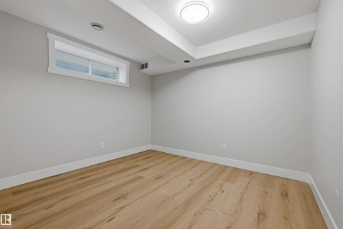 Wood-finish flooring, white trim, and a flush-mount ceiling light - 3830 22 Street Nw, Edmonton, AB 