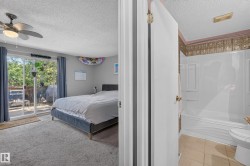 Carpeted bedroom with a ceiling fan, sliding glass door, and exterior wooden decking - 