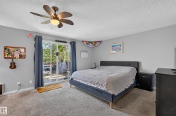 Sliding glass door, ceiling fan, and carpeted flooring - 