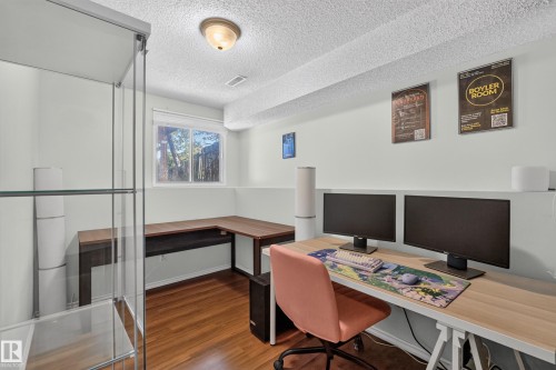 Wood-finish flooring, built-in display shelving, and an integrated corner desk - 333 Kirkpatrick Crescent Nw, Edmonton, AB 