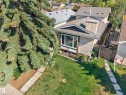 Exterior featuring stucco finish, a prominent chimney, and a shingled roof - 333 Kirkpatrick Crescent Nw, Edmonton, AB 