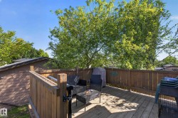 Outdoor wood-plank deck with a wood privacy fence - 