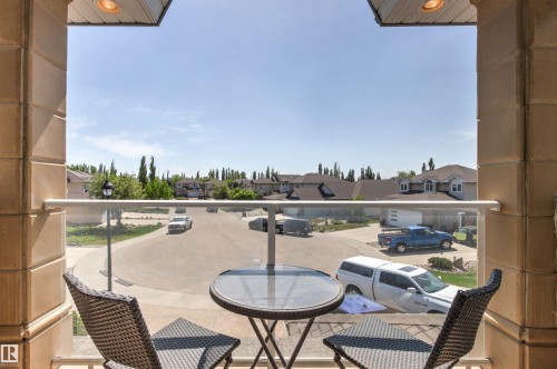 Balcony with glass railing and decorative stone pillars - 703 107A Street Sw, Edmonton, AB 