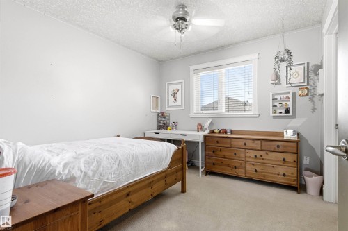 Bright room featuring a window with blinds, a ceiling fan, and light-colored walls - 703 107A Street Sw, Edmonton, AB 
