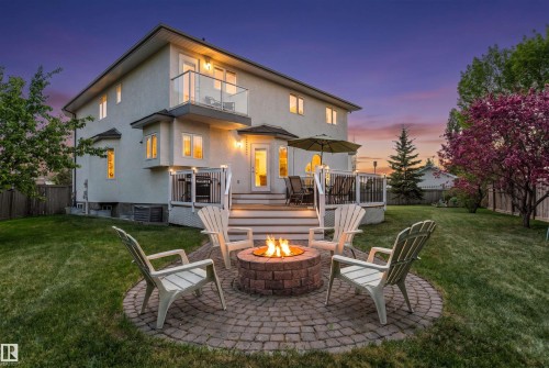 Expansive backyard featuring a brick paver fire pit area - 703 107A Street Sw, Edmonton, AB 
