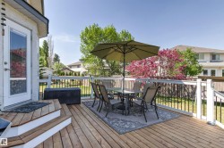 Expansive wood deck with white railings and black balusters - 
