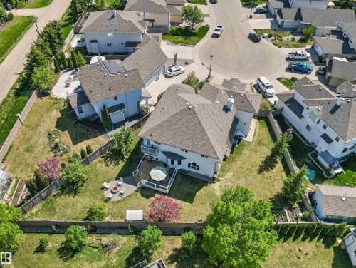 Expansive residential property featuring a large backyard, multi-level decking, and a paved patio area - 703 107A Street Sw, Edmonton, AB 