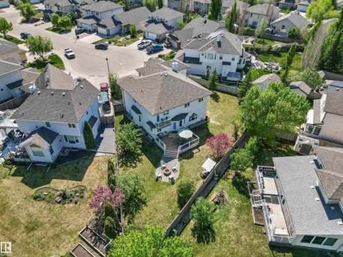 Spacious backyard with a multi-level deck, concrete patio, and mature trees - 703 107A Street Sw, Edmonton, AB 