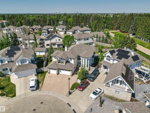 Traditional-style residence featuring a prominent bay window, attached two-car garage, and a paved driveway - 703 107A Street Sw, Edmonton, AB 