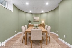 Recessed lighting, wood-finish flooring, white trim, and a window - 
