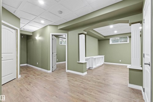 Wood-finish flooring, recessed lighting, coffered ceiling, built-in shelving, and architectural columns - 703 107A Street Sw, Edmonton, AB 