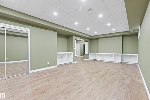Recessed lighting illuminates the wood-finish flooring - 703 107A Street Sw, Edmonton, AB 