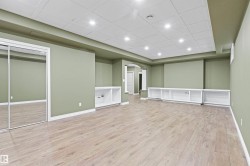 Recessed lighting illuminates the wood-finish flooring - 