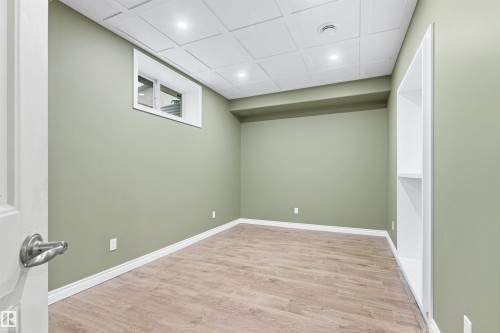 Wood-finish flooring with white trim, recessed lighting, and a coffered ceiling - 703 107A Street Sw, Edmonton, AB 