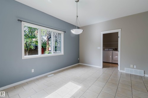 Recessed ceiling light, built-in shelving, tile flooring, window with white frame, and white trim - 11608 96 Street Nw, Edmonton, AB 
