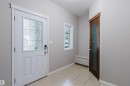 Tiled entry with a white paneled front door, secure keypad entry, and a side window - 11608 96 Street Nw, Edmonton, AB 