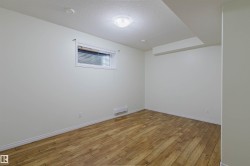 Room featuring wood-finish flooring, recessed lighting, and a ceiling-mounted light fixture - 