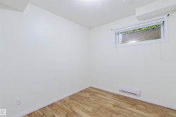 Wood-finish flooring, white painted walls, and a window with blinds - 