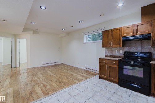 Recessed lighting and wood-finish flooring in the living area - 11608 96 Street Nw, Edmonton, AB 