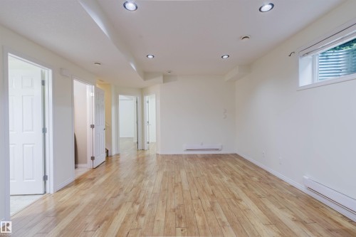 Wood-finish flooring throughout, recessed ceiling lighting, and multiple panel doors - 11608 96 Street Nw, Edmonton, AB 