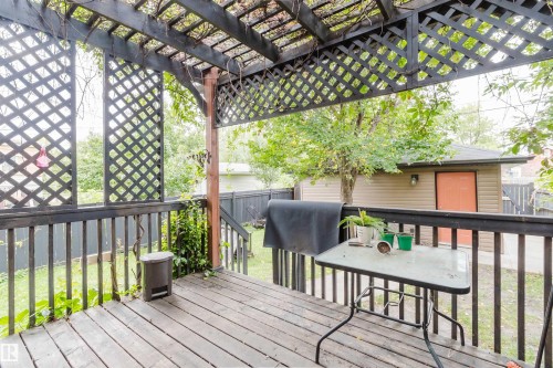 Wood-finish deck with a dark-stained wood pergola and lattice detailing - 11608 96 Street Nw, Edmonton, AB 