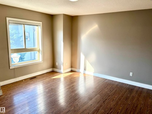 Wood-finish flooring, neutral wall tones, and white trim - #17 16317 64 St Nw, Edmonton, AB 