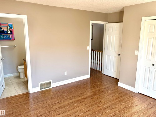 Wood-finish flooring throughout, with a neutral wall palette - #17 16317 64 St Nw, Edmonton, AB 