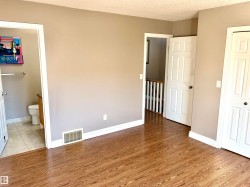 Wood-finish flooring throughout, with a neutral wall palette - 